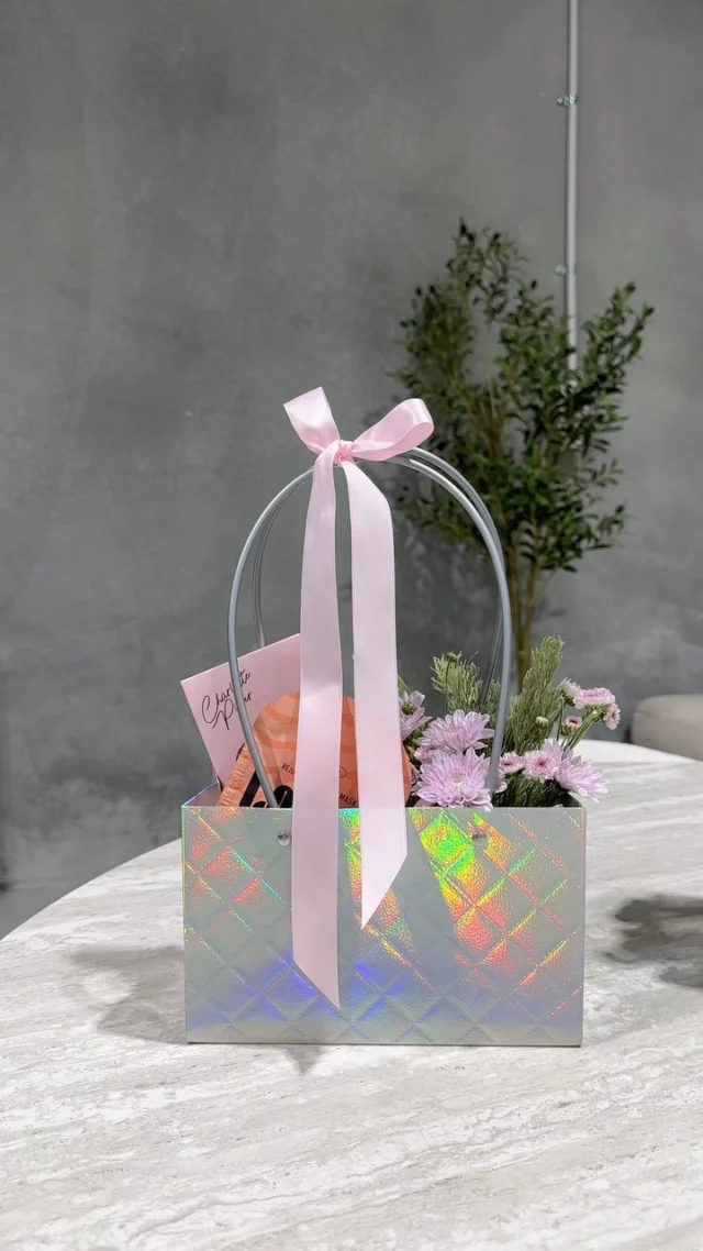 Meet our latest limited edition Holographic Flower Carrier ✨💗

Filled with fresh flowers, chocolate and thoughtful little extras, all packed into one very shiny delivery.

Available now while stock lasts.

#PerthGiftDelivery #PerthFlowers #PerthGifts #FlowerGift #SugarCoatIt